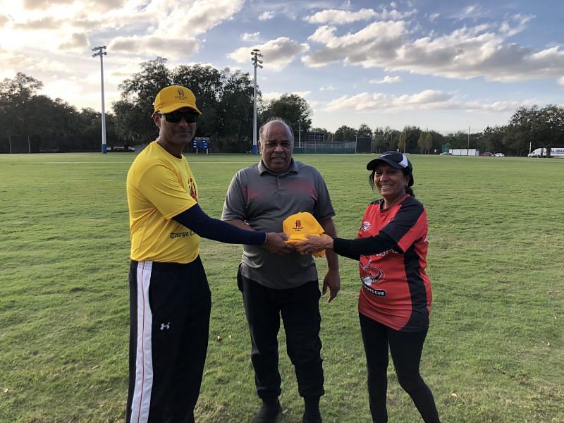 Nitesh Shetty, President TCL present TCL cap & Shirt to Coach Jatin Patel with Jyotsna Patel